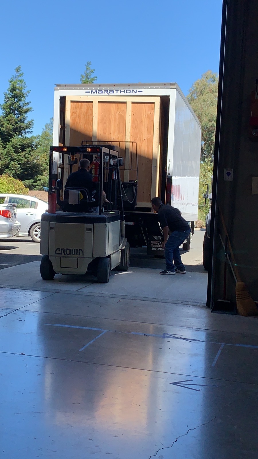 Fork lift loads large crate into truck