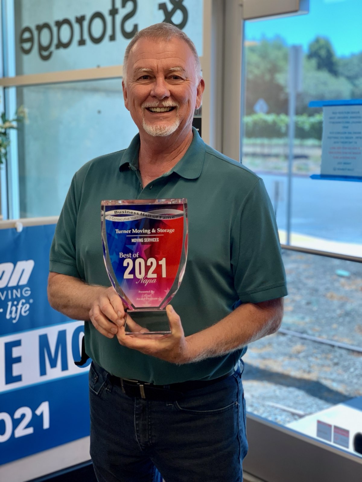 Randy Turner holding the Wheaton Agent of the Month for April 2021 award.