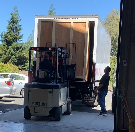Turner Moving & Storage forklift loading custom crating into a moving truck