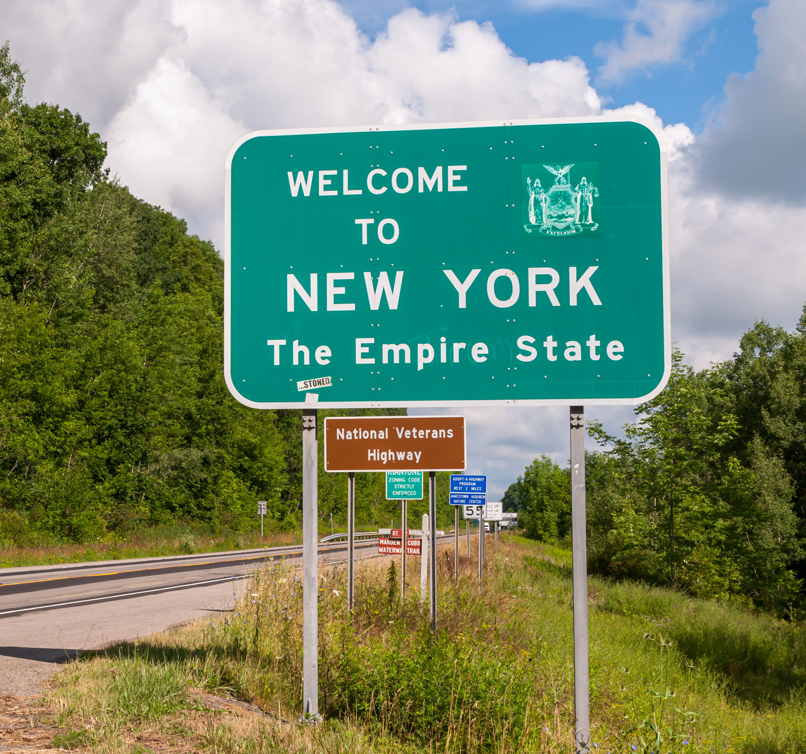 The Welcome to New York state line sign on US Route 62 in Chauta