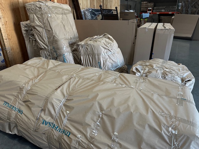 items wrapped in paper pads ready for overseas shipping