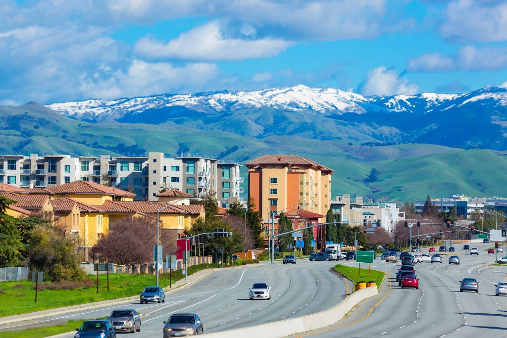 Street in San Jose, Calif., in early spring with snow on top of nearby mountain