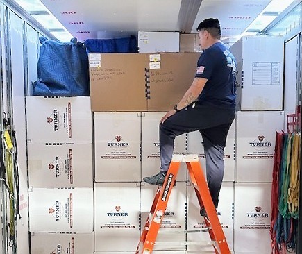Moving crew member packing a truck